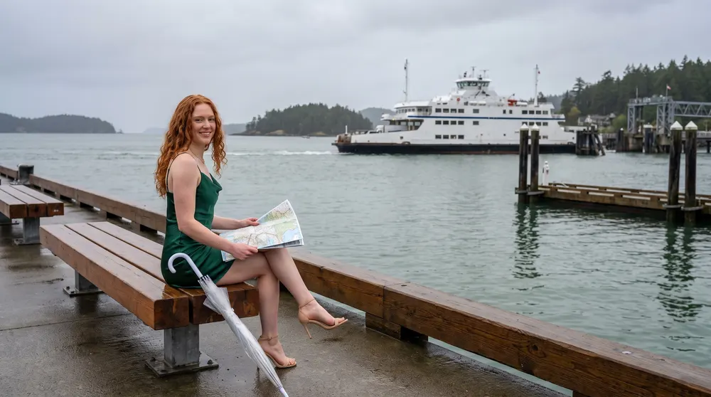A woman on a harbour bench with a road map
